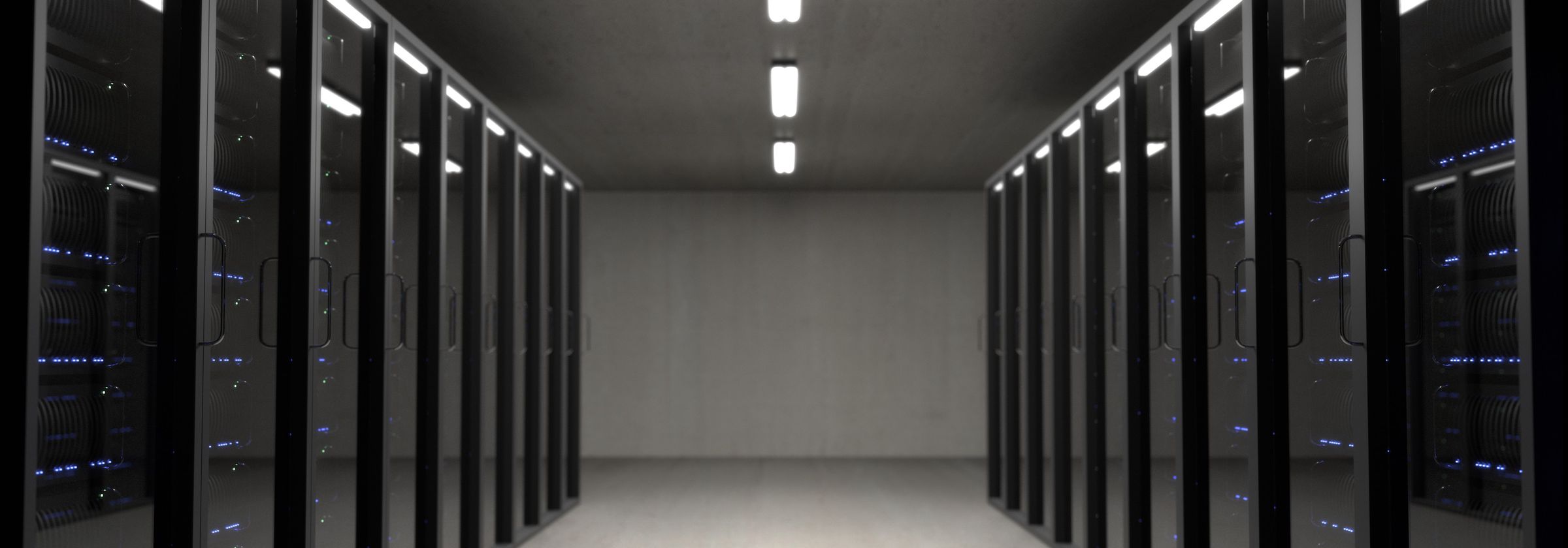 A lit corridor between server racks in an enterprise data centre