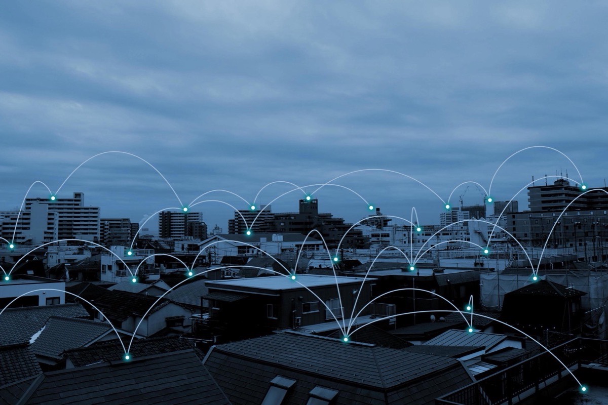 Network connections drawn over a city skyline