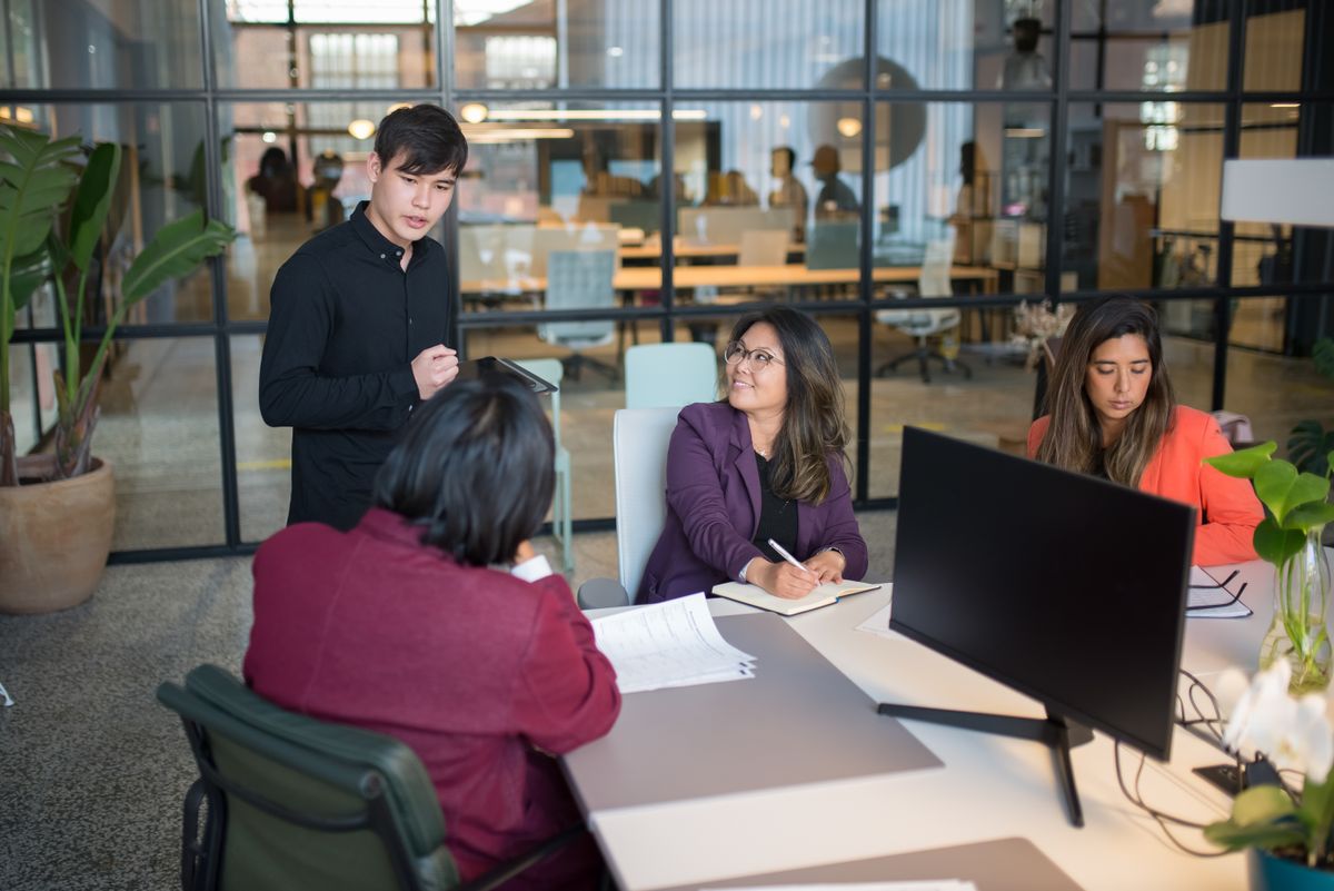 Office team reviewing enterprise resource planning reports together during a planning session