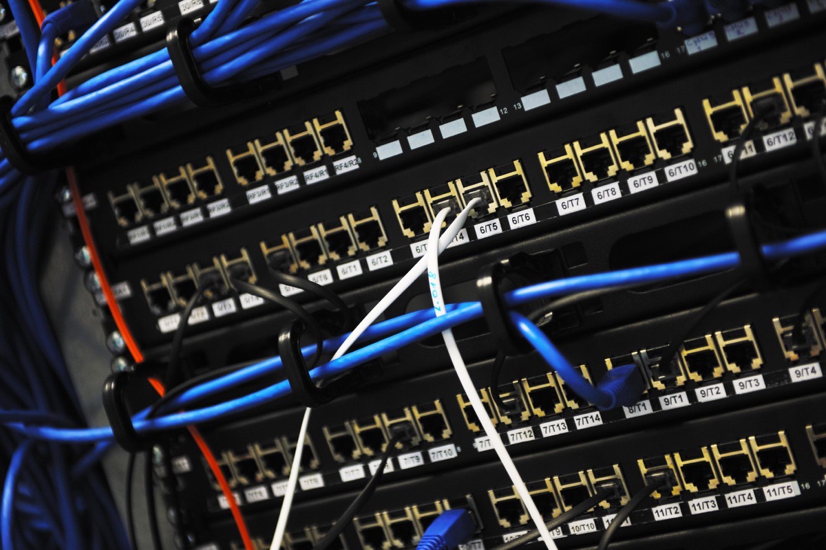 Numbered ports on a structured cabling patch panel, each labelled and patched to a switch