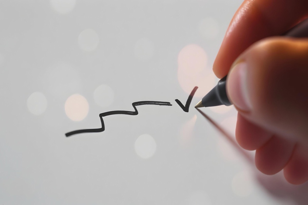 Hand ticking off steps on a whiteboard checklist